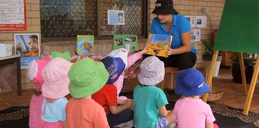Early childhood educator does shared reading with children