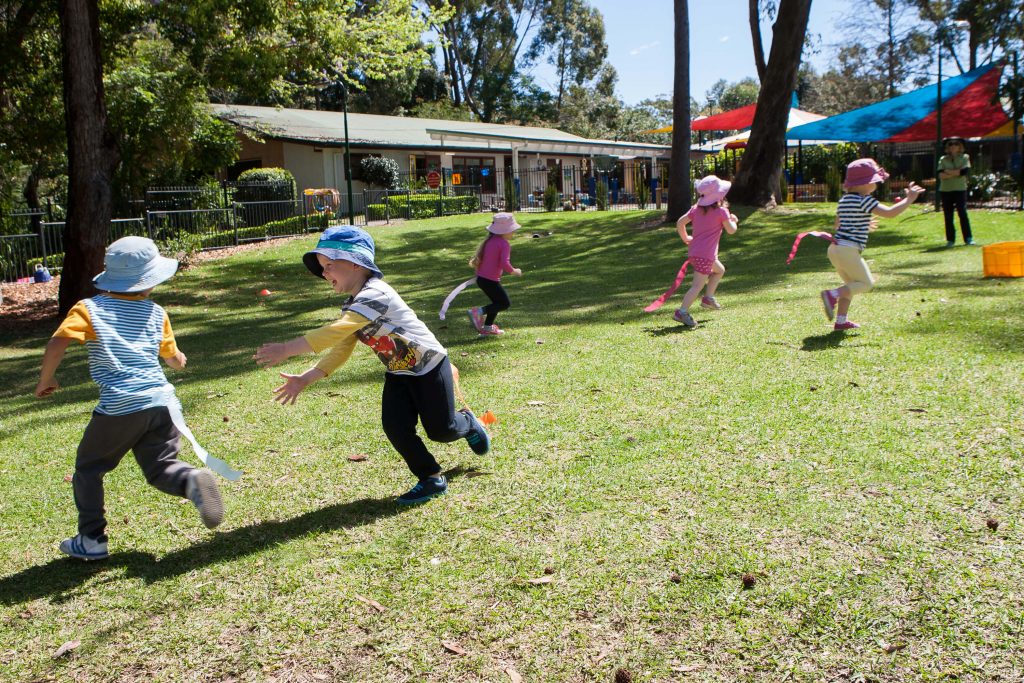 Five children play rabbit tag together